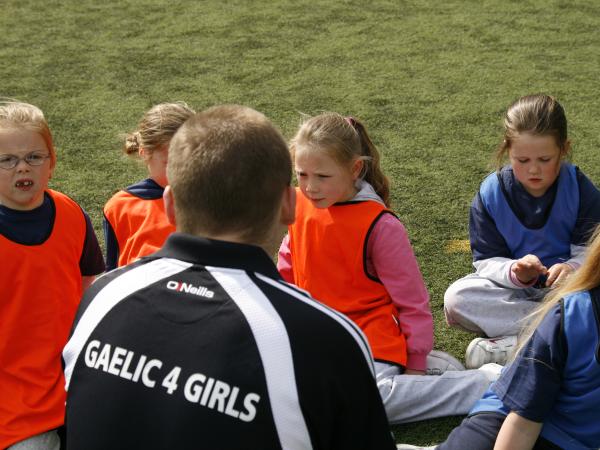 Gaelic4 Girls coach working with a group of children