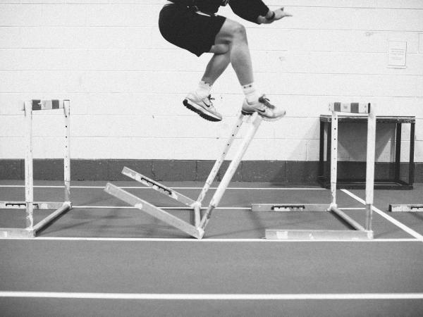 person jumping over obstacle