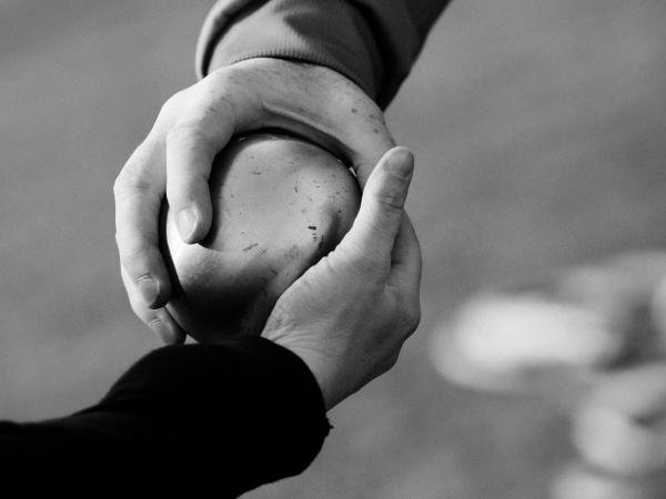 Two people holding a ball