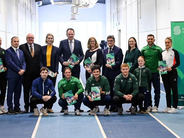 Ministers of Sport, Sport Ireland Representatives, and carded athletes holding up the 2026 High Performance Investment Brochure