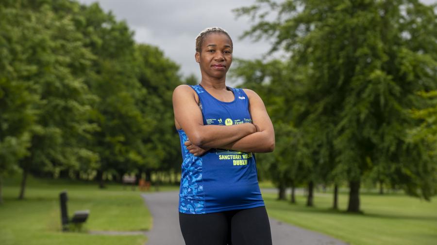 Amara Onwuzulumba stands in running gear looking at the camera with arms folded