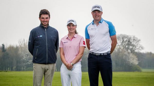 three golfers pose for a photo