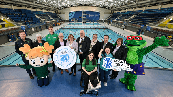 A group of people celebrating the 20th Anniversary of the National Aquatic Centre