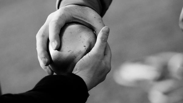 Two people holding a ball