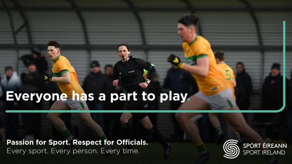 Female referee and two players playing Ladies Gaelic Football