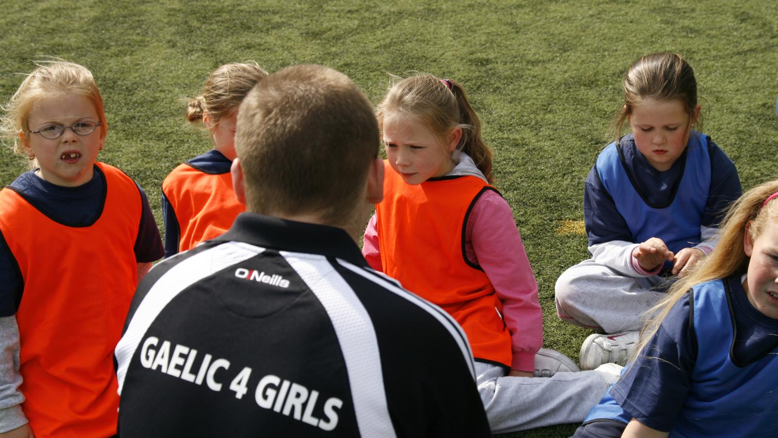 Gaelic4 Girls coach working with a group of children