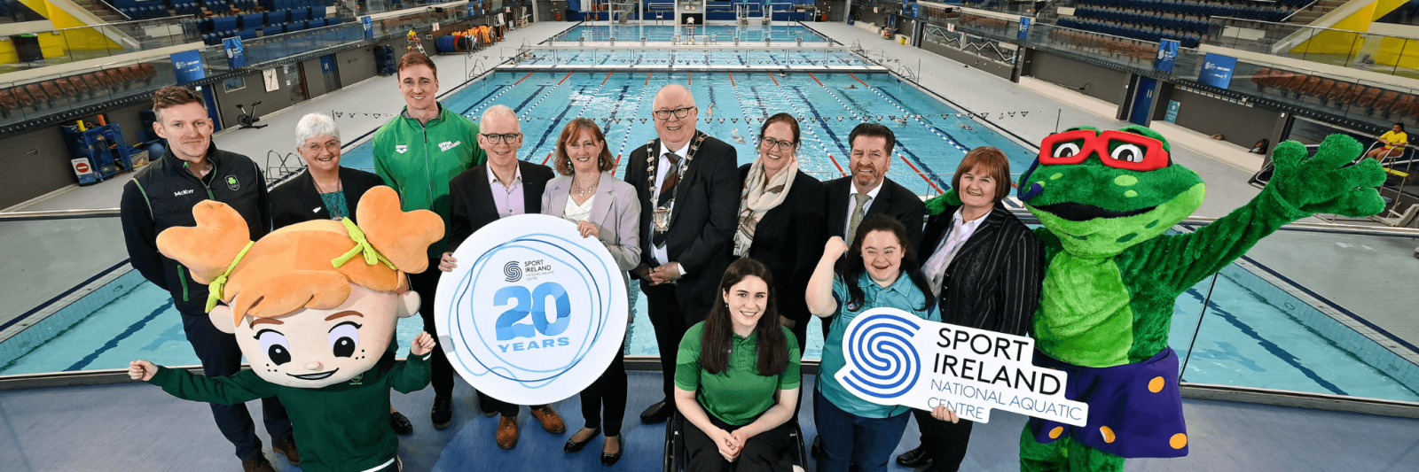 A group of people celebrating the 20th Anniversary of the National Aquatic Centre