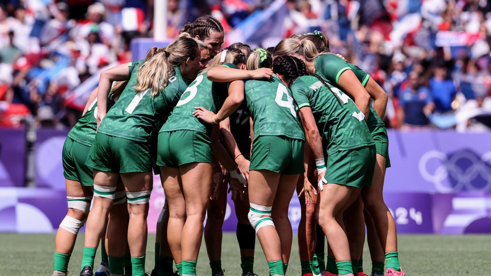 Team in a group huddle.