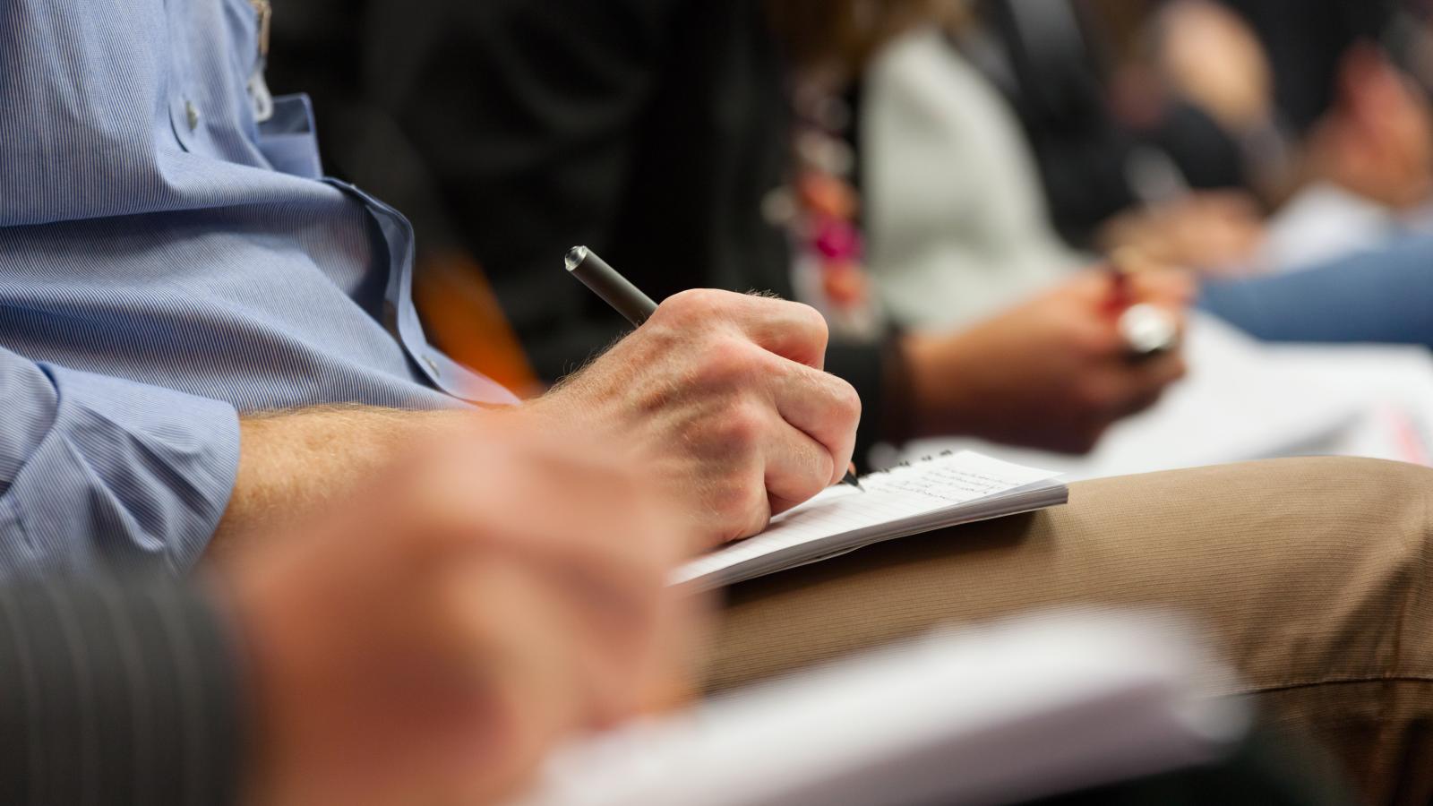 People writing on paper