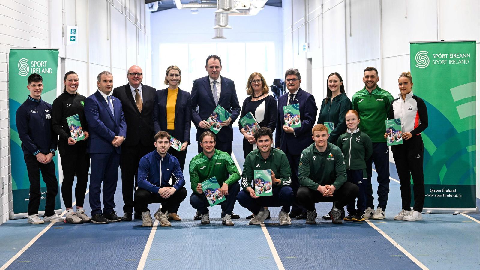 Ministers of Sport, Sport Ireland Representatives, and carded athletes holding up the 2026 High Performance Investment Brochure